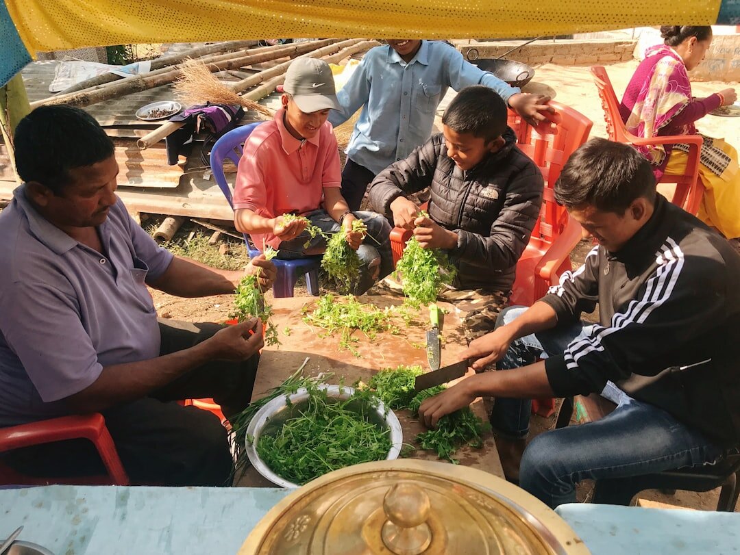 Group of seniors cooking together in a community kitchen